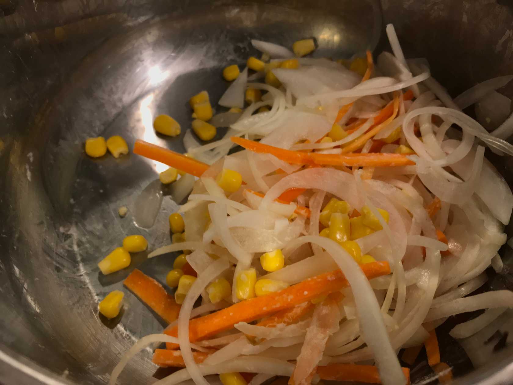 Carrots, onions, and corns in a bowl
